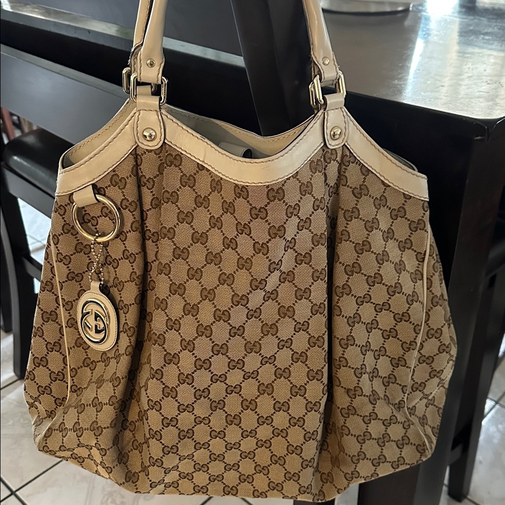 Gucci Brown Monogram Tote
18 W 15 L handle 6